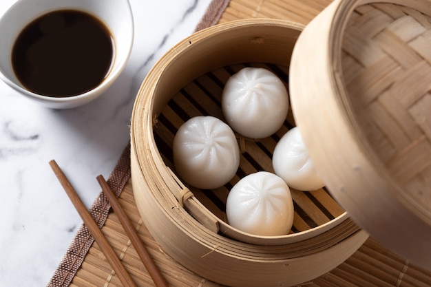 Steamed dumplings on white marble background Traditional oriental food