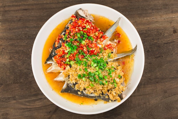 Photo steamed fish head with diced hot red peppers