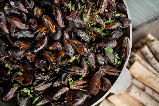 Steamed mussels Fresh mussels at grill pan Seafood barbecue outdoors mussels in shells