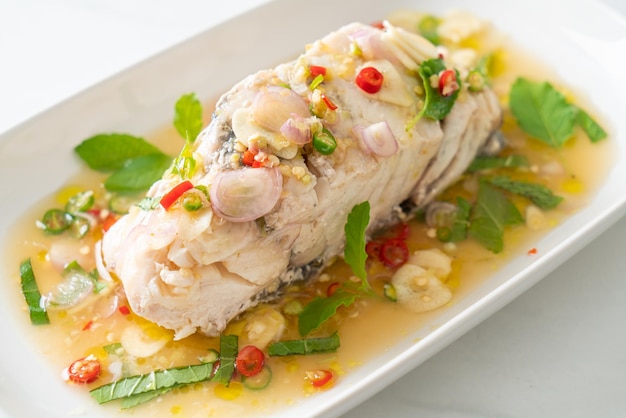 Steamed sea bass fish with herbs