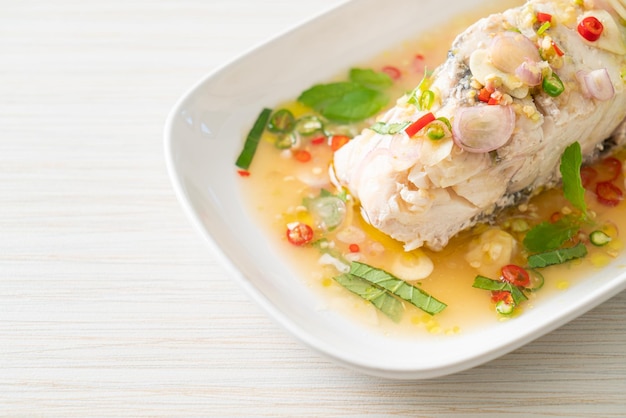 Premium Photo | Steamed sea bass fish with herbs