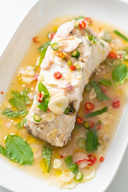 Steamed sea bass fish with herbs