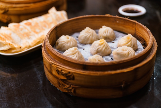 Steamed Xiao Long Bao (Soup Dumplings) in The Bamboo Basket. Served in Restaurant in Taipei, Taiwan.