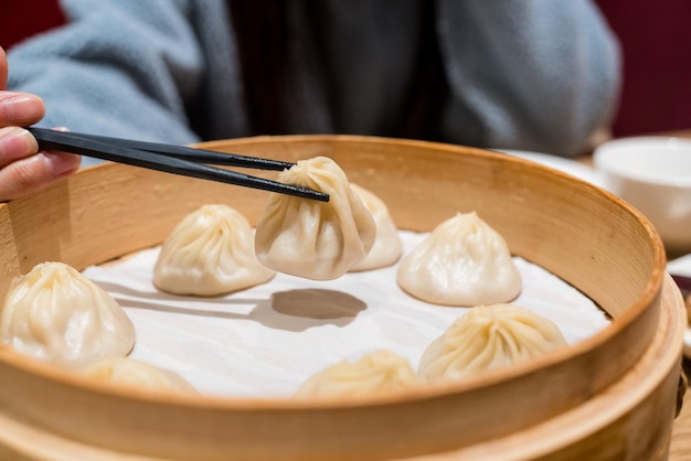 Foto xiaolongbao al vapore servito in un tradizionale cesto di bambù