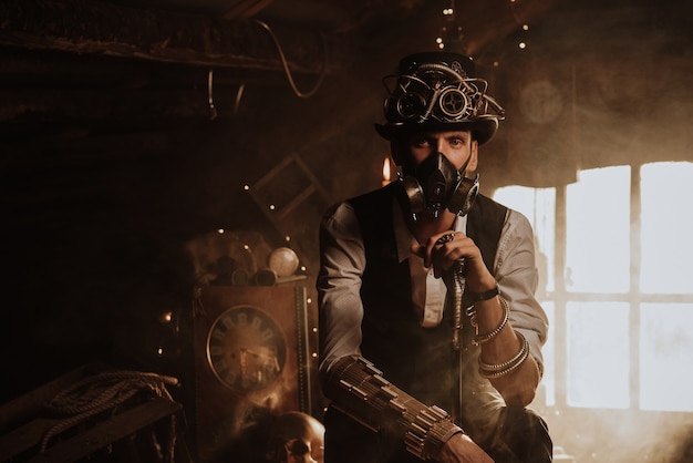 Steampunk cosplay. Portrait of a man in a top hat, glasses and a gas mask with a cane in his hand