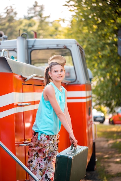 Steampunk girl in the hat on old steam locomotive.