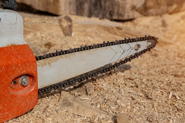 Steel chain chainsaw sawing firewood outdoors