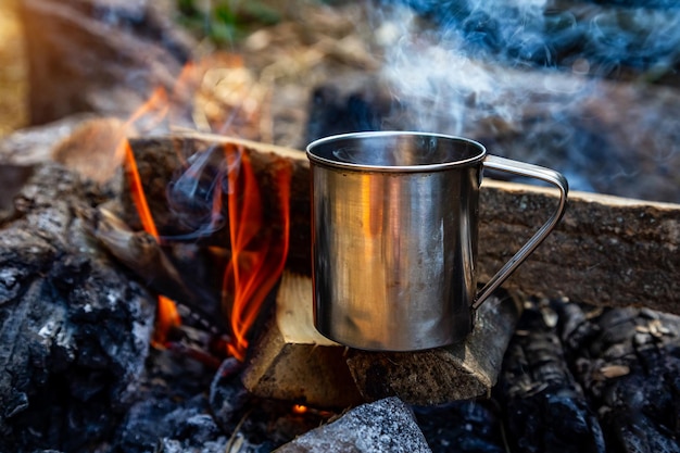Steel cup on an open fire in nature