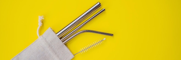 Steel drinking straws on a yellow background zero waste concept banner long format