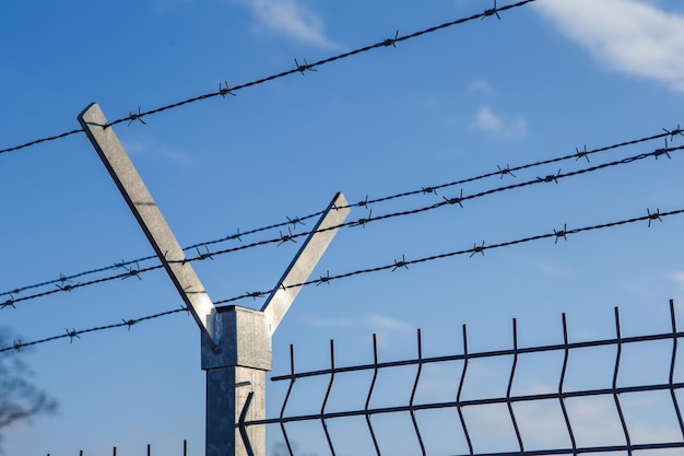 Steel fence with barbed wire