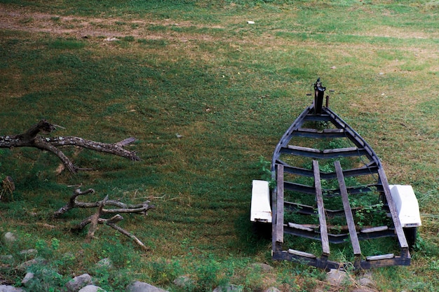 Steel frame for carrying boats to move, moored on the grass.