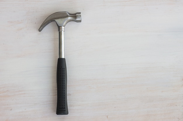 steel hammer rubble handle on white wood 