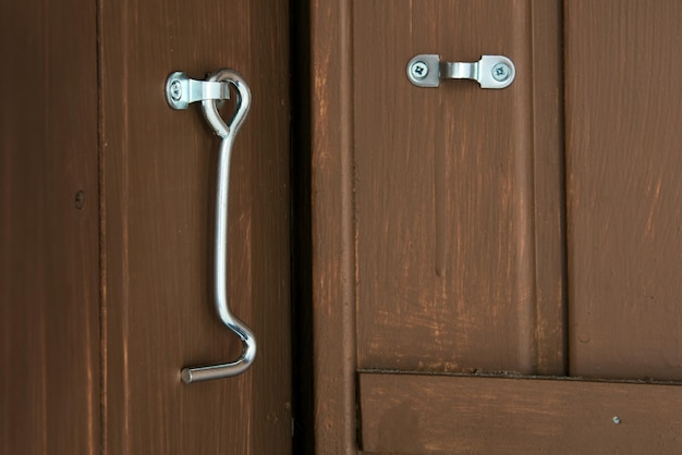 Steel hook for locking doors in utility rooms