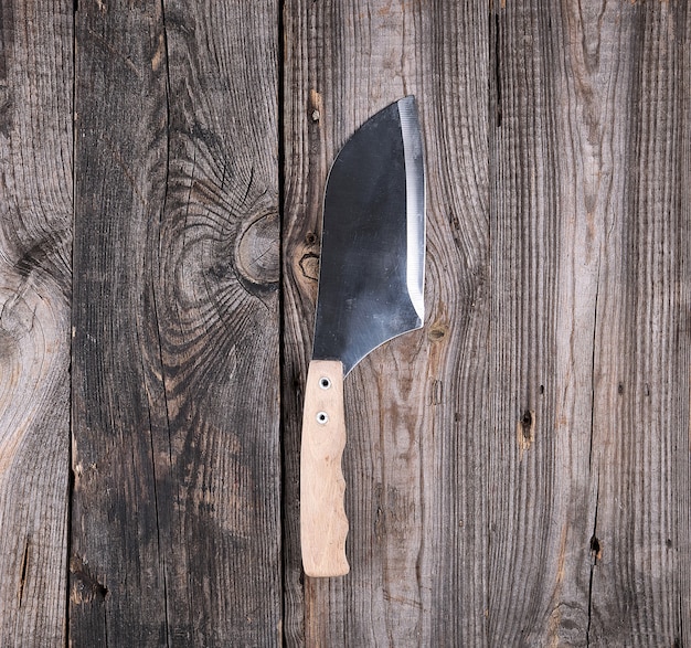 Steel knife for cutting meat with a wooden handle 