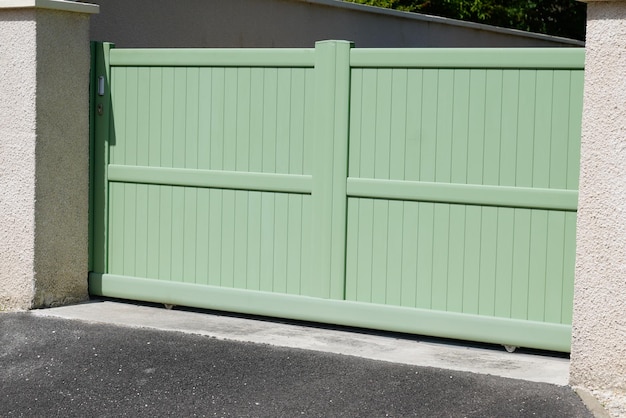 Steel large green clear metal gate fence on modern house street