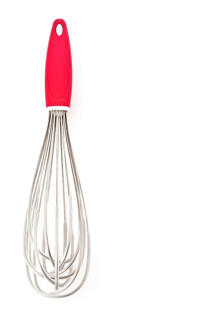 Photo steel manual whisk with plastic lid and red handle for pastry white background space for text