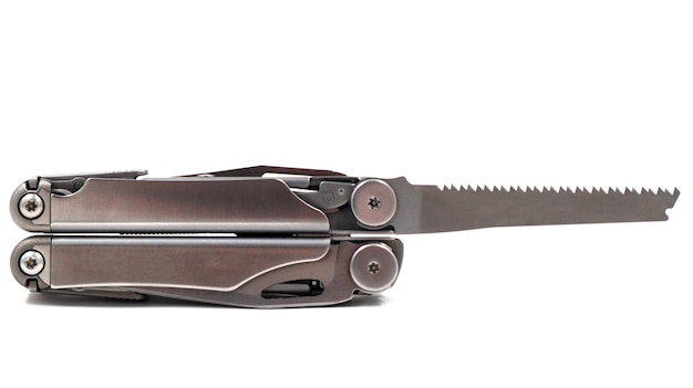 A steel multitool or pocket knife with an open saw lies on a white background compact and portable