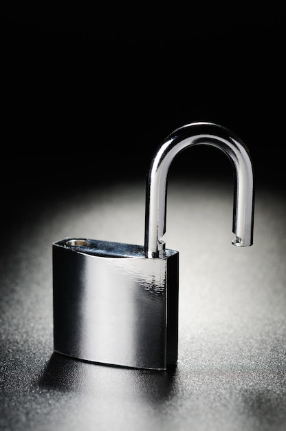 Steel padlock on the black textured background
