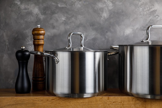 Steel pots on a gray background