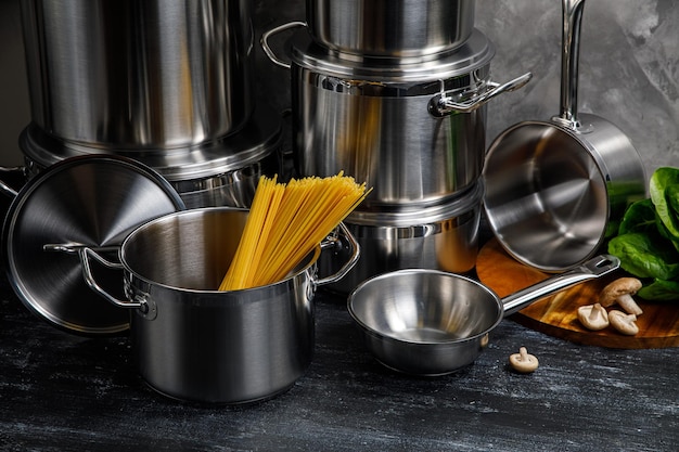 Steel pots on a gray background