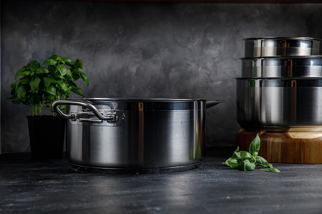 Steel pots on a gray background