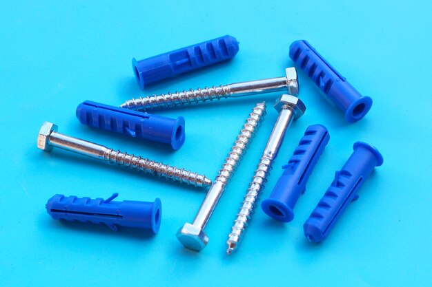 Steel screws on blue background