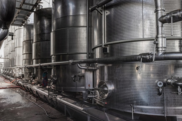 Steel tanks for wine fermentation at a modern winery Large brewery silos for barley or beer