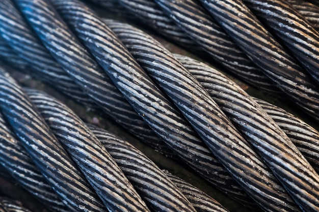 Photo steel twisted cable wound on a drum next to each other closeup