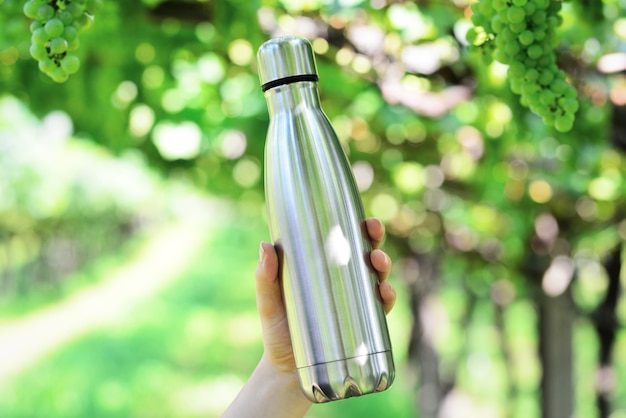 Steel water bottle on vineyard background