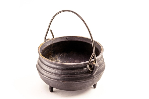 Steel witch cauldron, Halloween decorative object on isolated white surface.