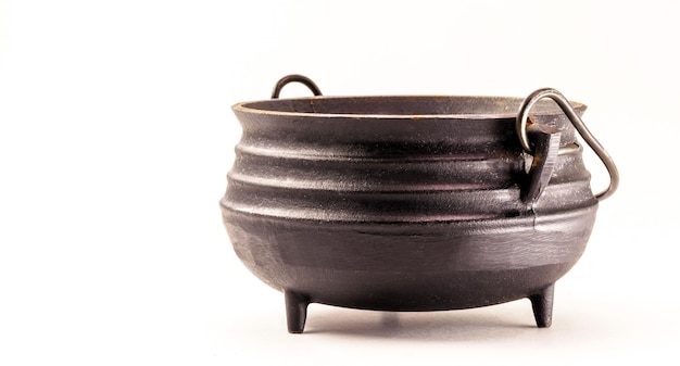 Photo steel witch cauldron, halloween decorative object on isolated white surface.