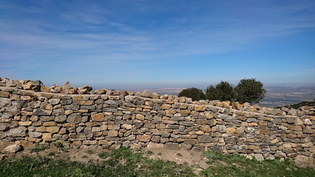 Steenmuur op de berg tegen de blauwe hemel.