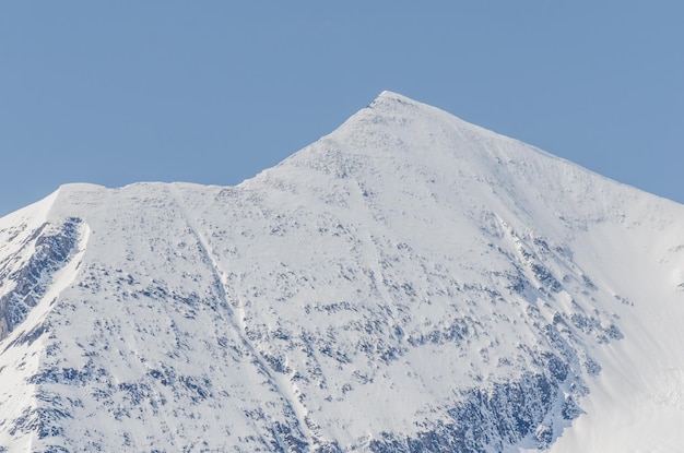 Steep high mountain with snow