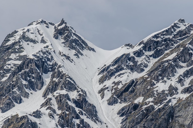 Steep mountain with trail of skier