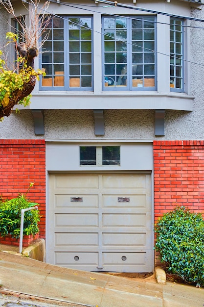 Steep road next to front of west coast home garage door