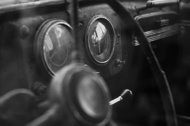 Steering wheel and dashboard of a vintage car Old shabby car interior