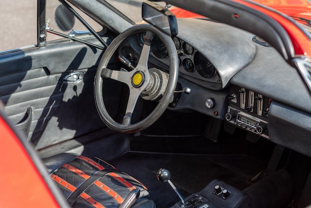 steering wheel with dashboard inside the Red vintage car