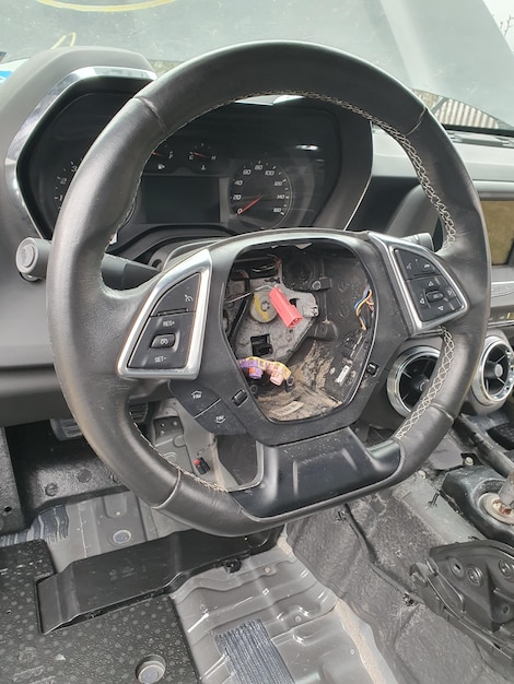 A steering wheel with a red handle and a red handle.