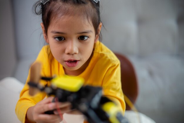 STEM education concept Asian students learn at home by coding robot arms in STEM mathematics engineering science technology computer code in robotics for kids' concepts