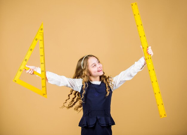 STEM学校は、小さな女の子を学校に戻す数学のレッスン教育と知識大きな支配者を持つ生徒の女の子学校の生徒が幾何学の幾何学の形を学ぶ