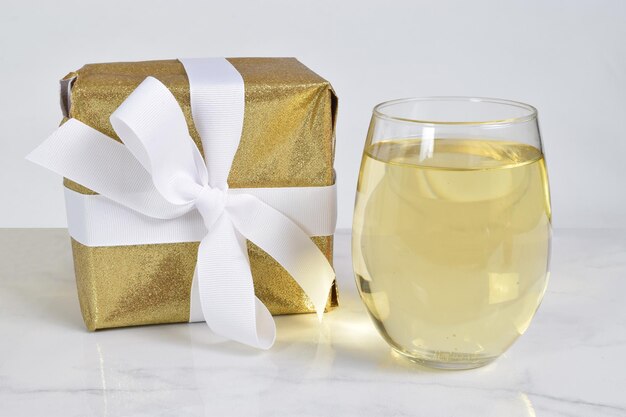 Stemless Wine Glass Mockup with White Wine and Present