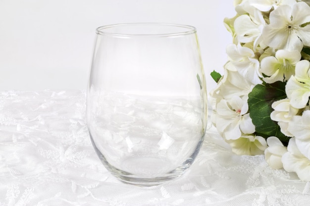 Stemless wineglass mockup with white flowers