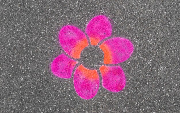 Photo stenciled graffiti flower on asphalt