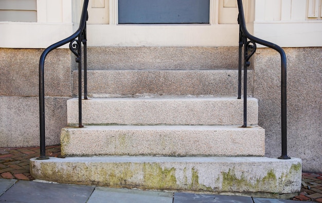 A step on a building with a sign on it that says " the front door ".