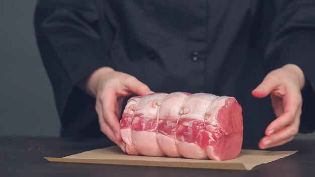 ステップバイステップ。茶色の肉屋の紙に骨なしのポークロースト。