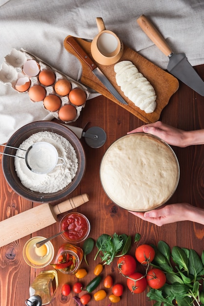 Step-by-step boss makes a pizza margarita. Dough and pizza ingredients