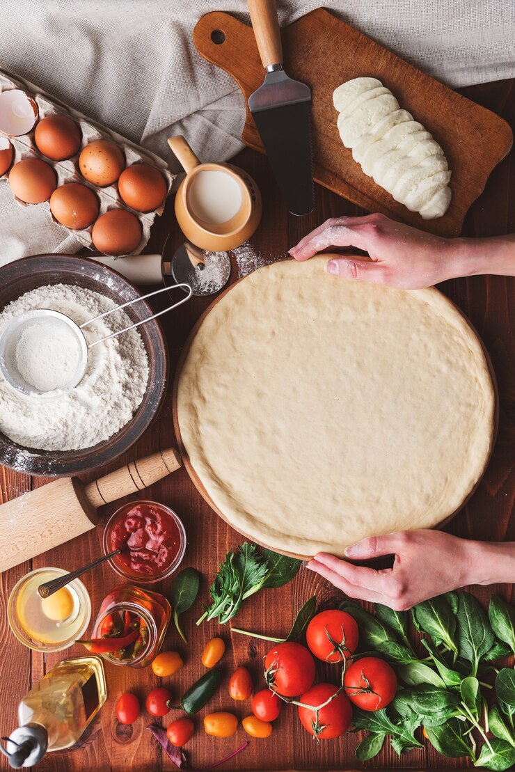 Photo step-by-step boss makes a pizza margarita. dough and pizza ingredients