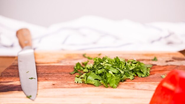 Step by step. Cutting vegetables to make filling for empanadas.