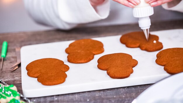 Step by step. Decorating gingerbread and sugar cookies with royal icing for Christmas.