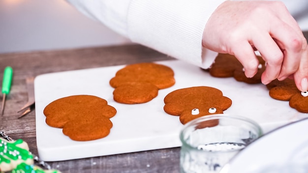 Step by step. Decorating gingerbread and sugar cookies with royal icing for Christmas.